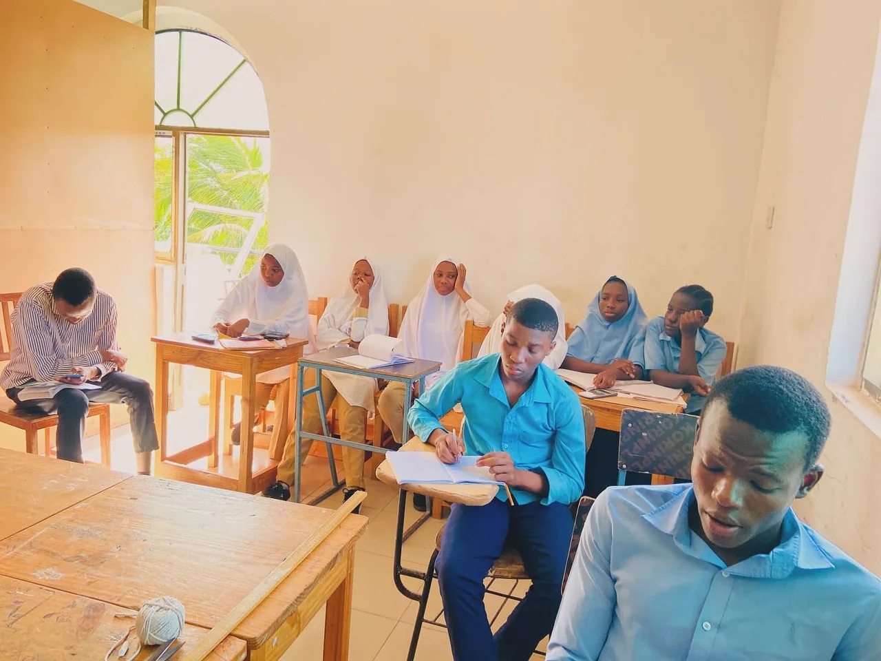 A teacher guiding pupils during a classroom lesson